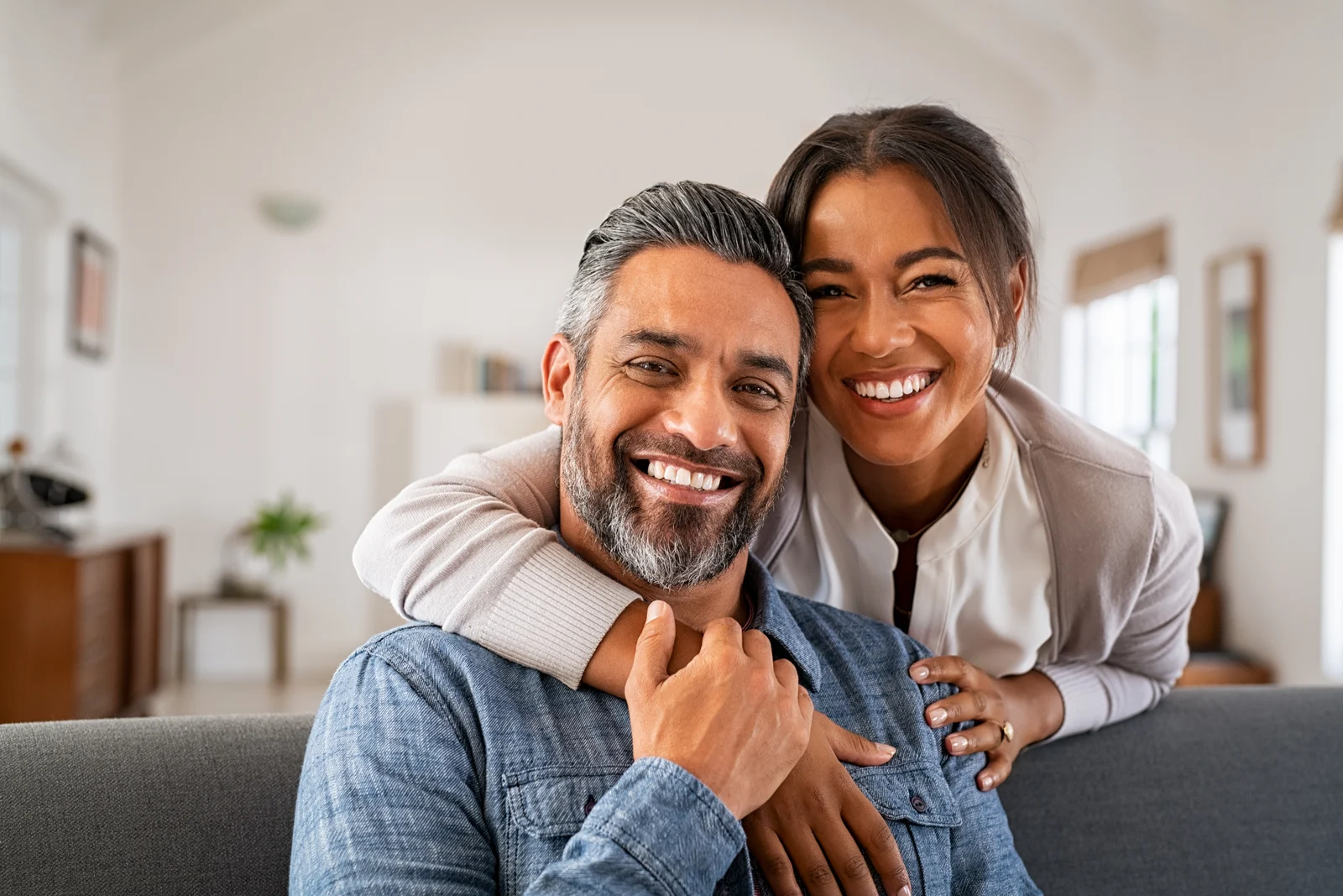 A smiling couple embracing at home